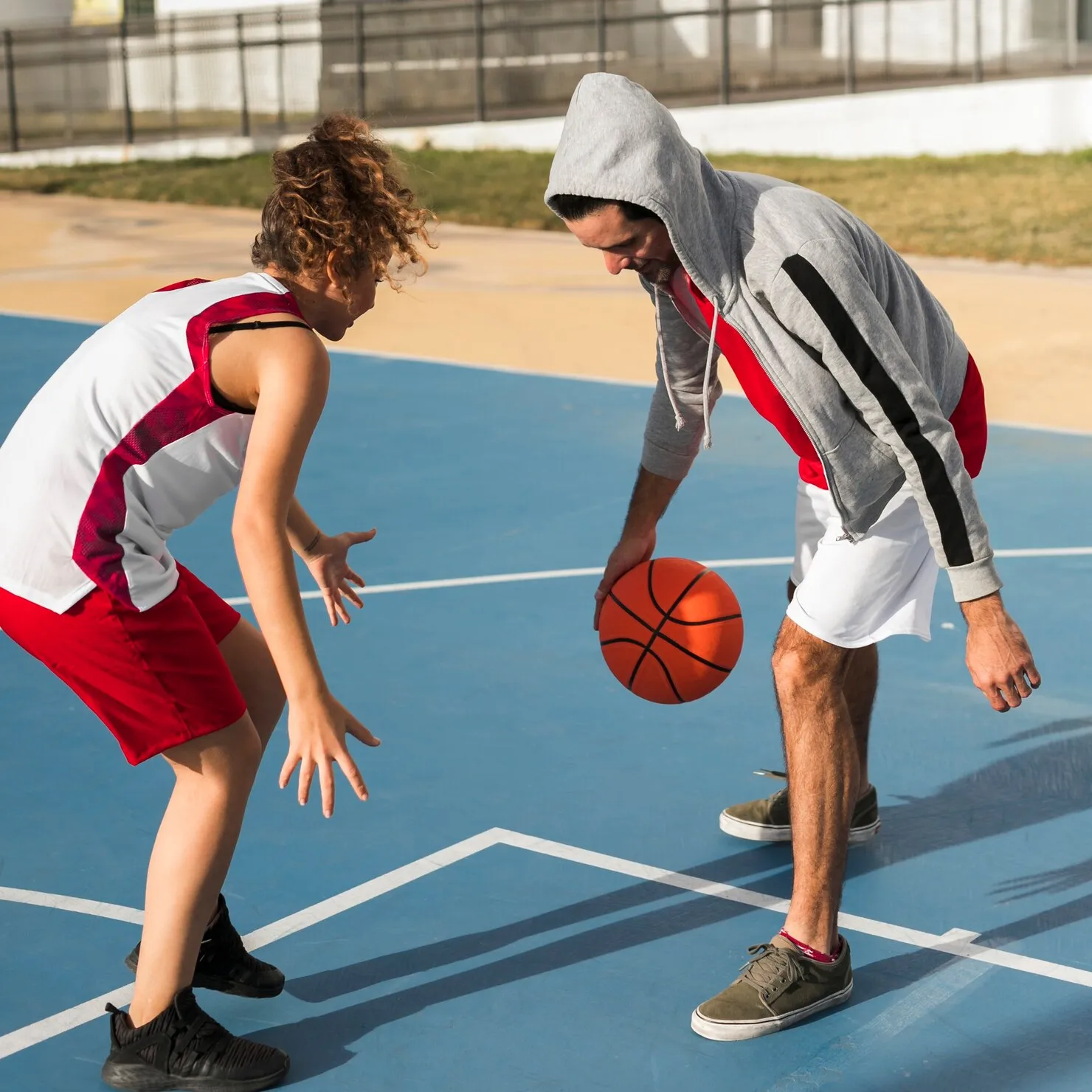 front-view-boy-girl-playing-basketball_23-2148459556_0L60
